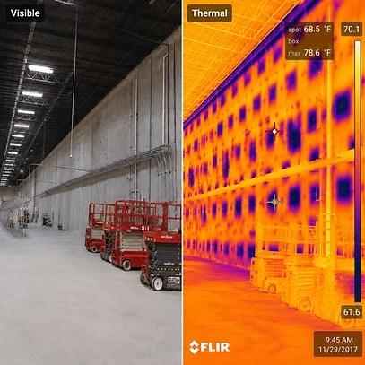 Side-by-side visible and thermal images of the same warehouse wall. The visible photograph shows a plain concrete panel wall that appears sound. The thermal frame of the identical view shows a strong pattern through the panels and their joints, with on-screen readings of spot 68.5 and box maximum 78.6 degrees Fahrenheit.